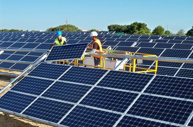 Green Solar Energy installation crew fixing solar panels